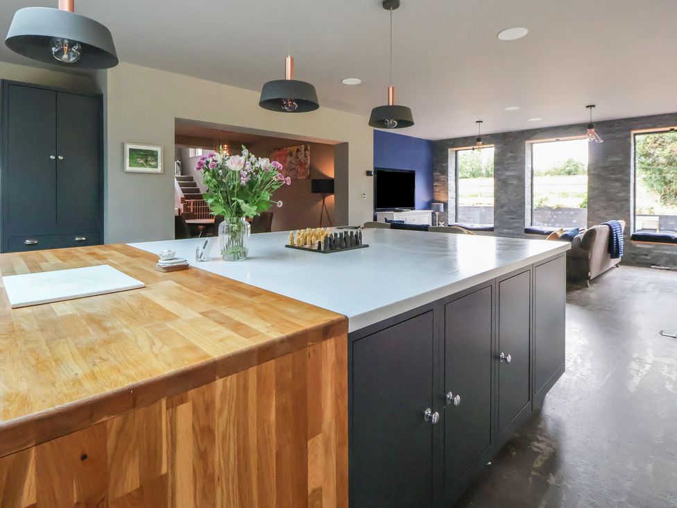 A kitchen with a countertop and flowers at Rook Hall Farm in Newcastle