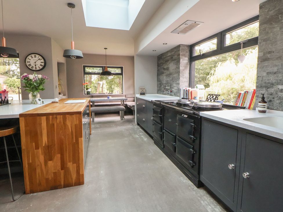 A kitchen with an island and an oven at Rook Hall Farm in Newcastle