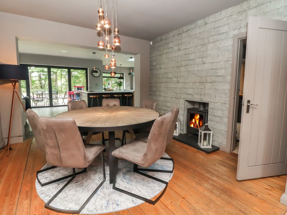 A dining room with a round table and chairs at Rook Hall Farm in Newcastle