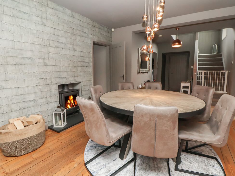 A dining room with a round table and chairs at Rook Hall Farm Newcastle
