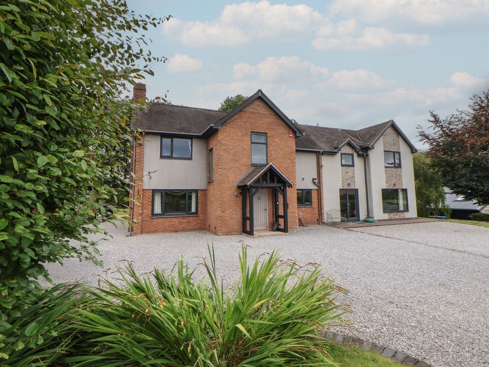 A house with a gravel driveway and parking area at Rook Hall Farm Butterton near Newcastle-Under-Lyme