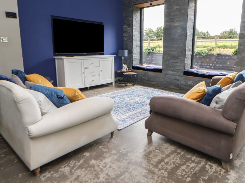 A living room with a television and sofas at Rook Hall Farm Butterton near Newcastle-Under-Lyme