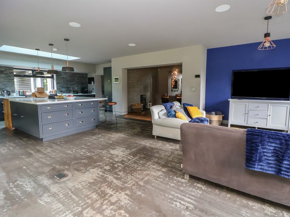 A living room with a kitchen island and sofa at Rook Hall Farm Butterton near Newcastle-Under-Lyme