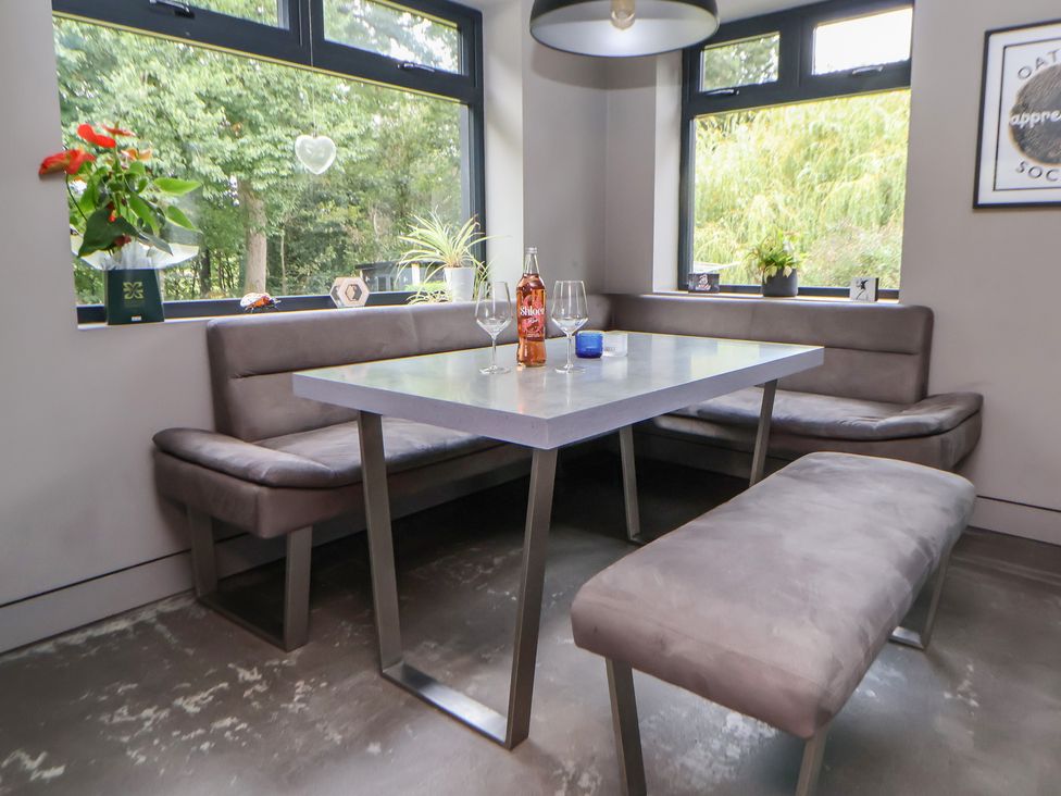 A dining area with a table and benches at Rook Hall Farm Butterton near Newcastle-Under-Lyme