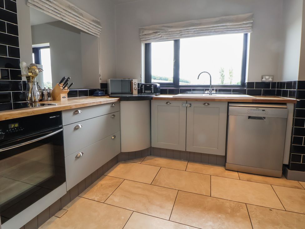 A kitchen with cabinets and appliances at Rook Hall Farm Butterton near Newcastle-Under-Lyme