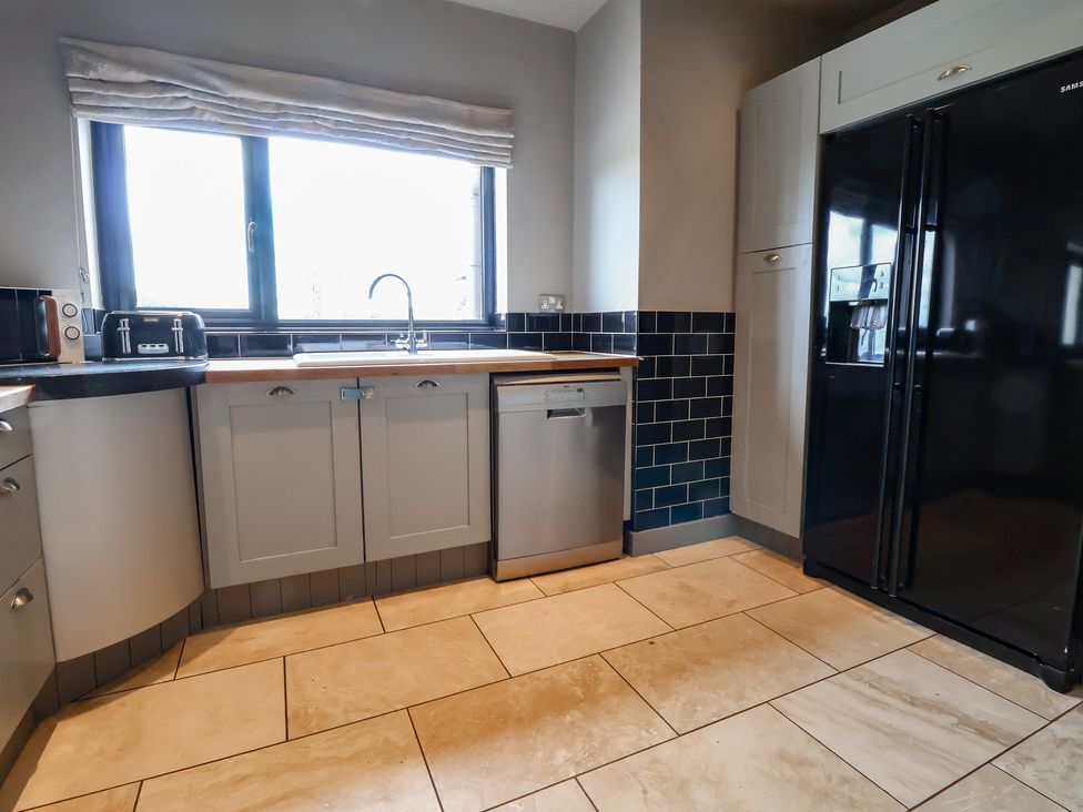 A kitchen with a sink and refrigerator at Rook Hall Farm Butterton near Newcastle-Under-Lyme