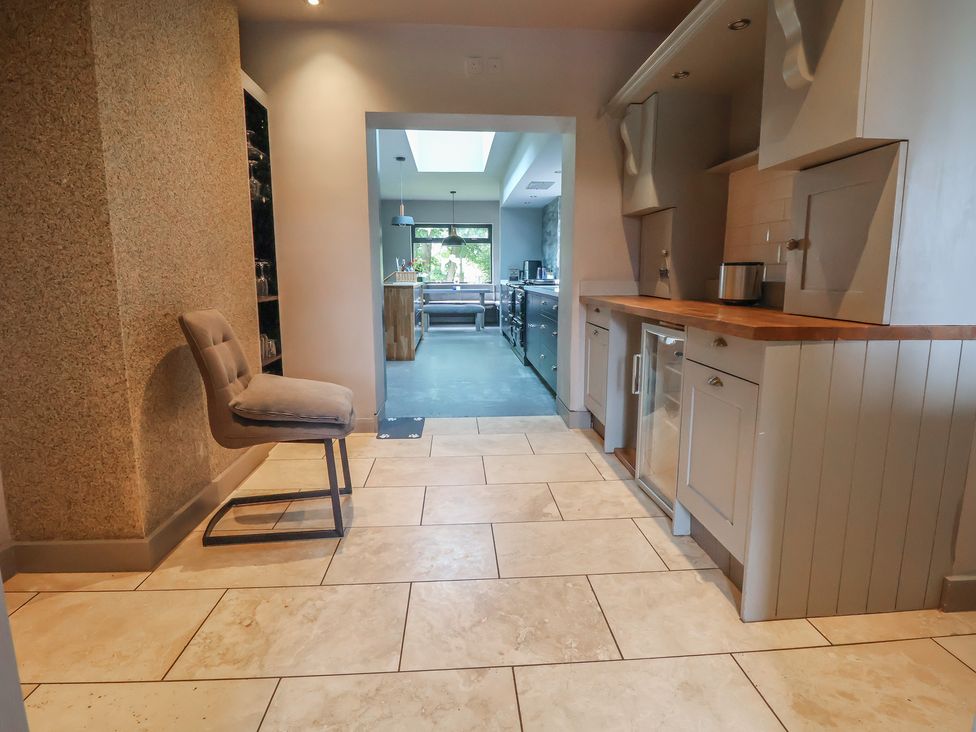 A kitchen with a bar stool and counter at Rook Hall Farm Butterton near Newcastle-Under-Lyme