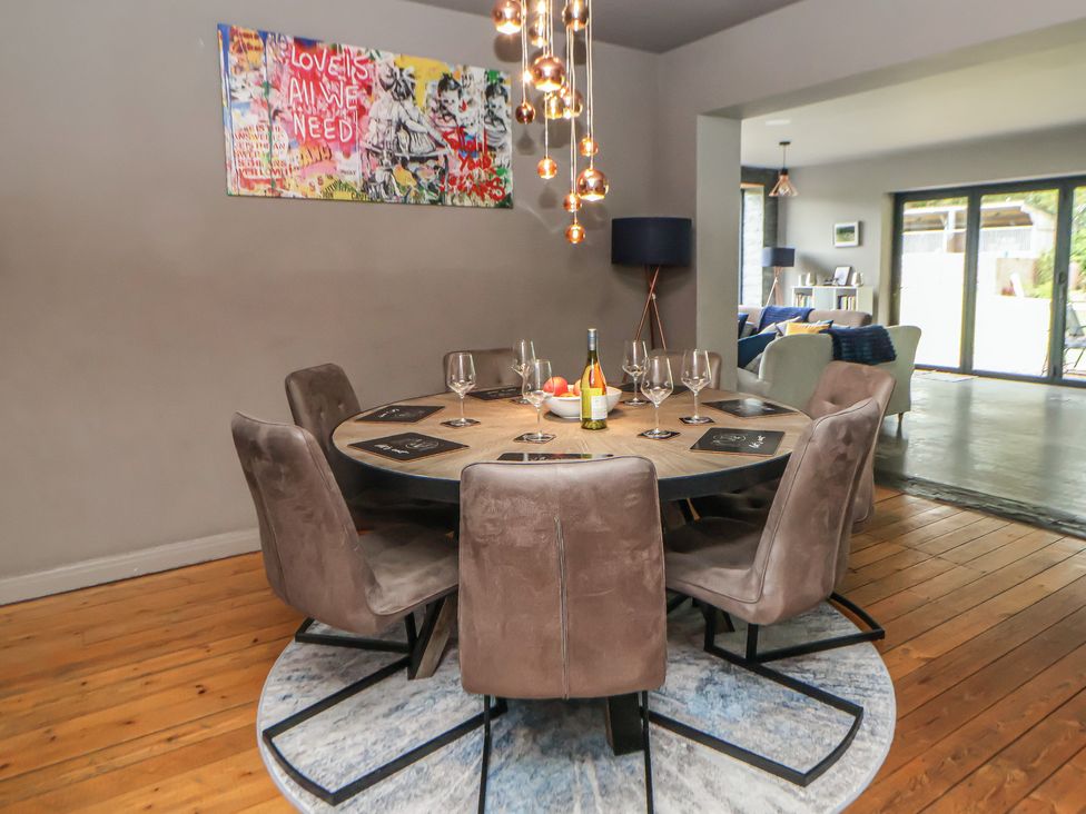 A dining room with a round table set for dinner at Rook Hall Farm Butterton near Newcastle-Under-Lyme