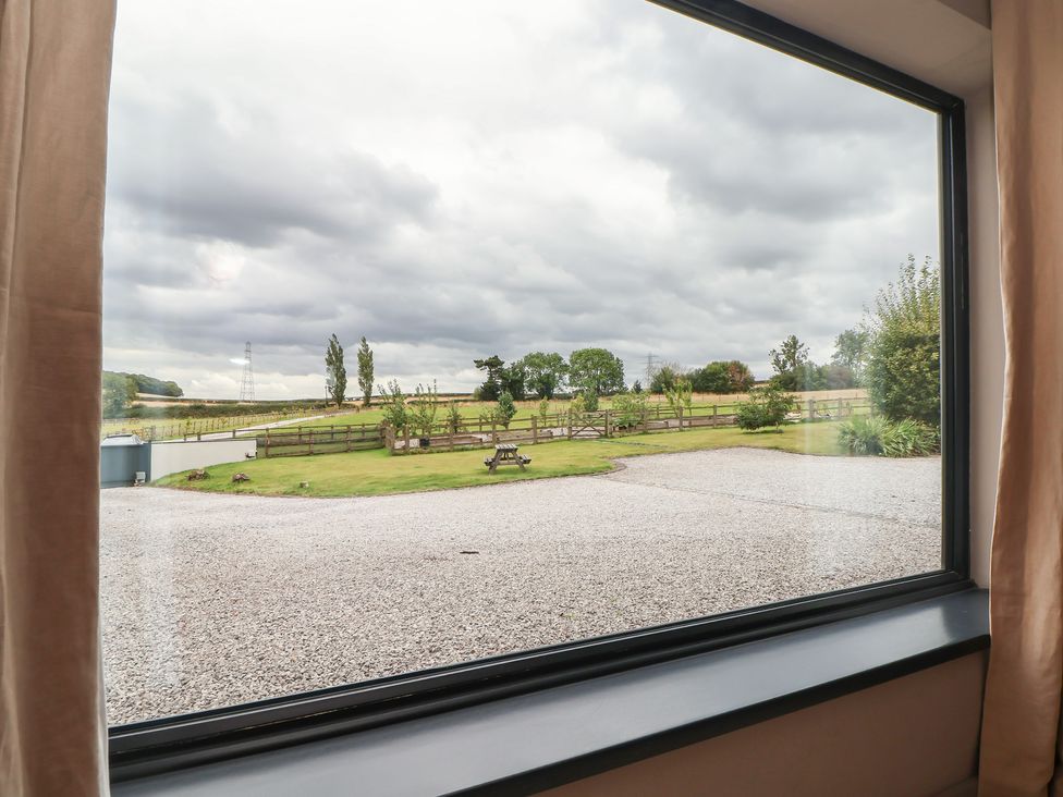 A view from a window showing a grassy area and trees at Rook Hall Farm Butterton near Newcastle-Under-Lyme
