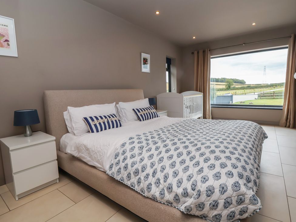 A bedroom with a bed and crib at Rook Hall Farm Butterton near Newcastle-Under-Lyme