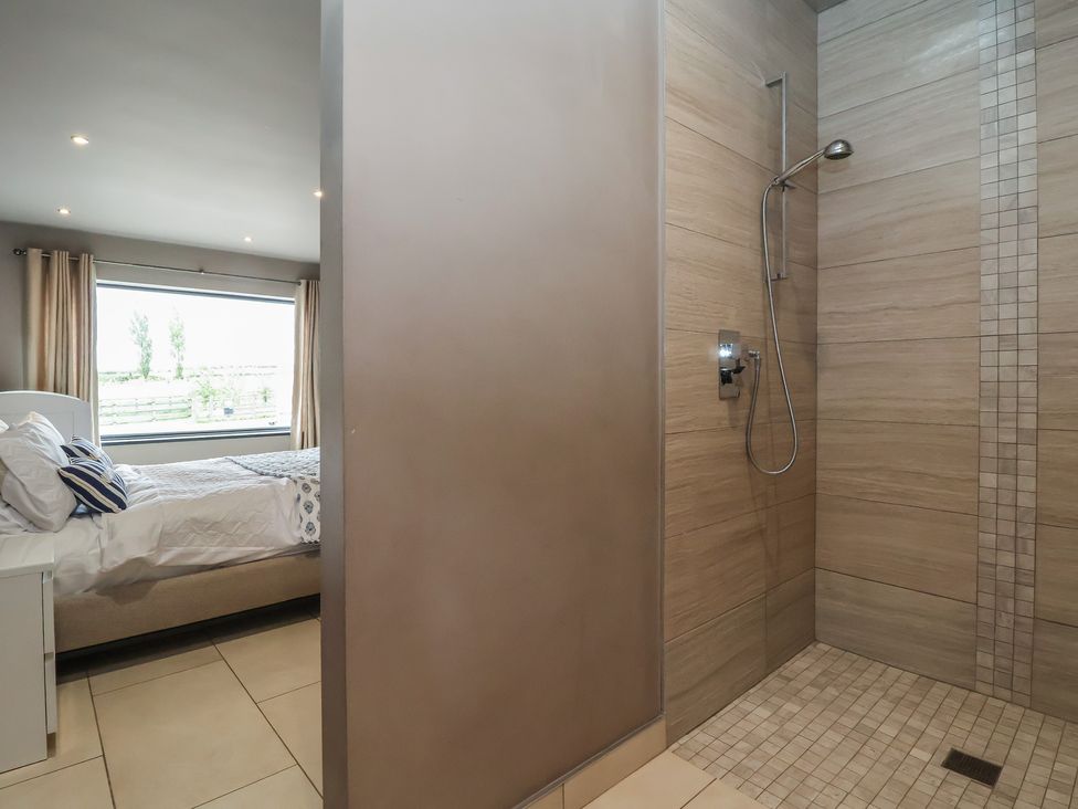A bedroom with a bed and a shower at Rook Hall Farm in Butterton near Newcastle-Under-Lyme