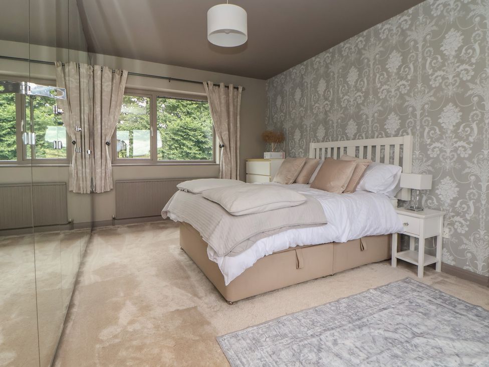 A bedroom with a bed and windows at Rook Hall Farm Butterton near Newcastle-Under-Lyme