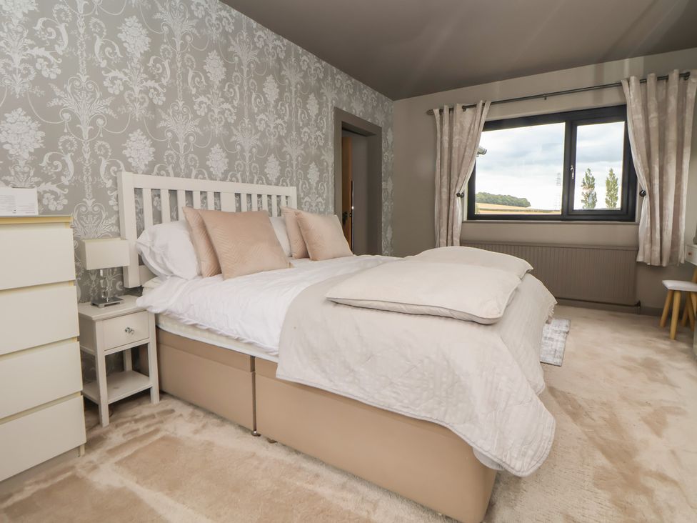 A bedroom with a bed and bedside table at Rook Hall Farm Butterton near Newcastle-Under-Lyme