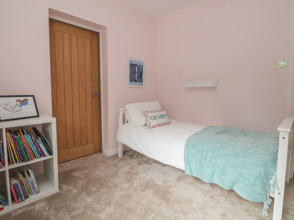 A bedroom with a bed and bookshelf at Rook Hall Farm in Butterton near Newcastle-Under-Lyme