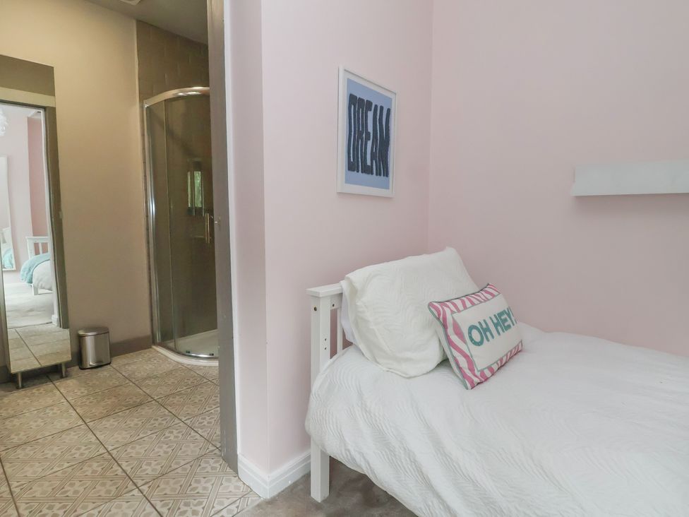 A bedroom with a bed, shower, and mirror at Rook Hall Farm near Butterton