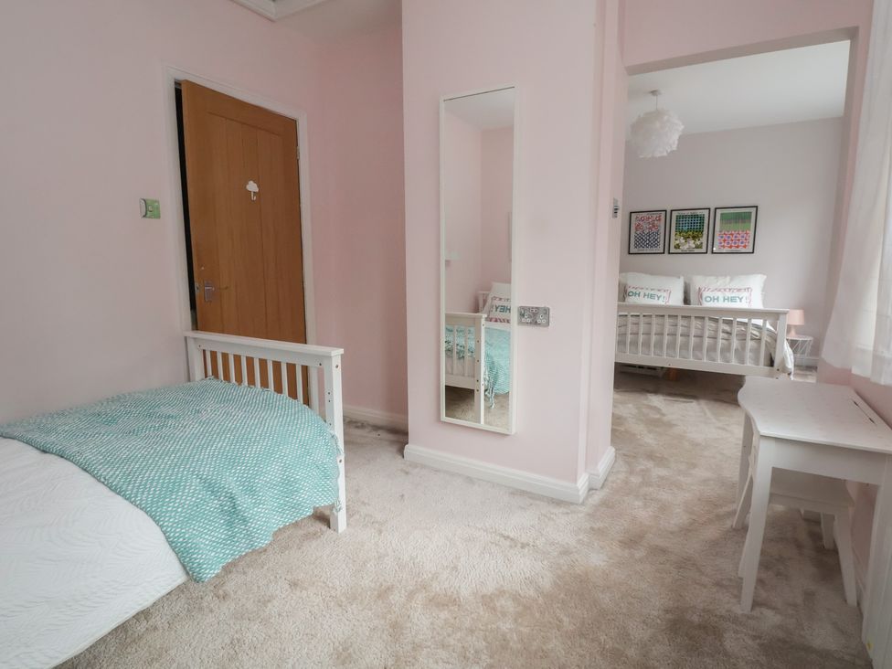 A bedroom with a bed and a mirror at Rook Hall Farm in Butterton near Newcastle-Under-Lyme