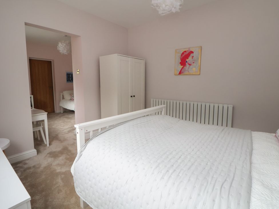 A bedroom with a bed and wardrobe at Rook Hall Farm Butterton near Newcastle-Under-Lyme