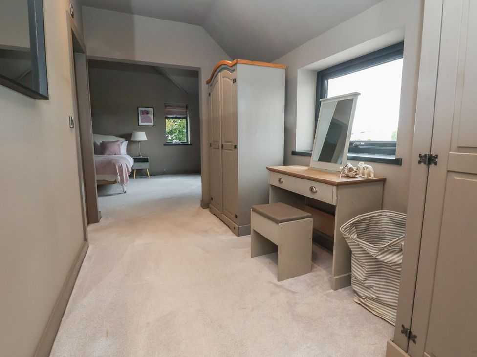 A bedroom with a wardrobe and a vanity table at Rook Hall Farm Butterton near Newcastle-Under-Lyme
