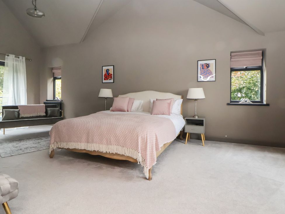 A bedroom with a bed and bedside table at Rook Hall Farm Butterton near Newcastle-Under-Lyme