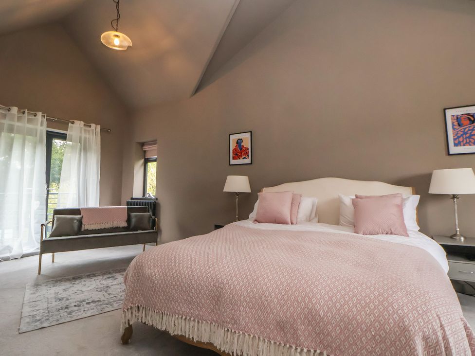 A bedroom with a bed and sofa at Rook Hall Farm Butterton near Newcastle-Under-Lyme