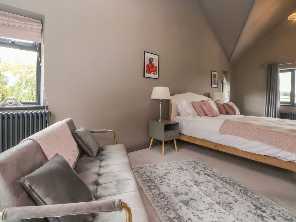 A bedroom with a bed and sofa at Rook Hall Farm Butterton near Newcastle-Under-Lyme