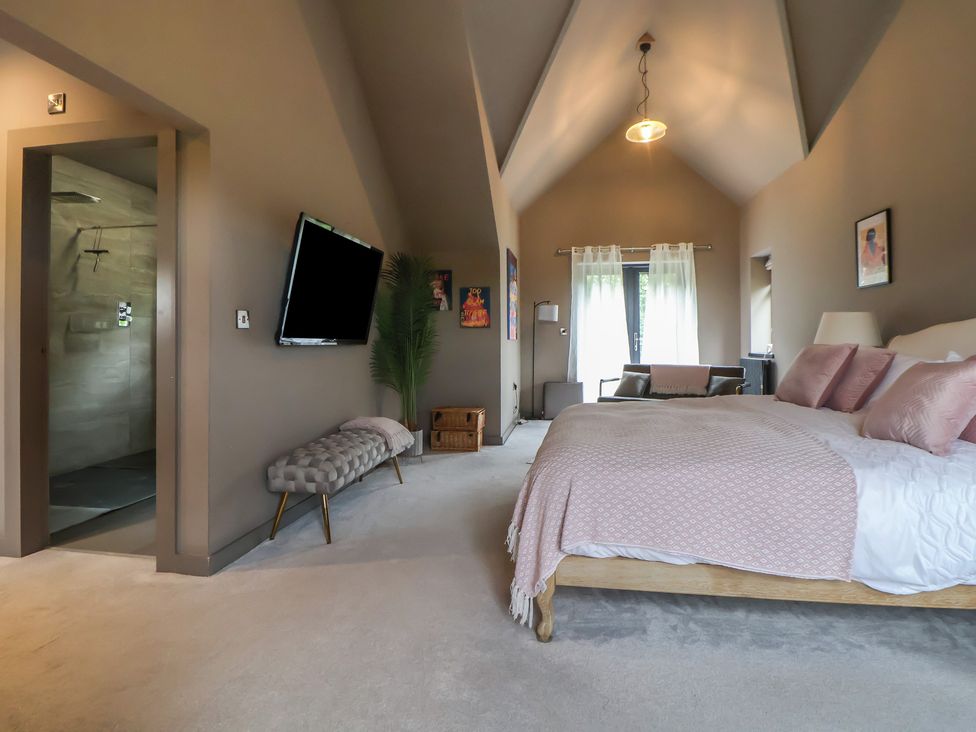 A bedroom with a bed and television at Rook Hall Farm Butterton near Newcastle-Under-Lyme