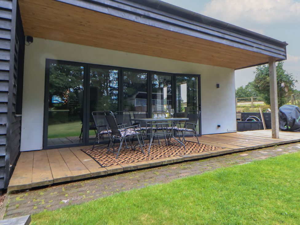 An outdoor patio with a table and chairs at Rook Hall Farm Butterton near Newcastle-Under-Lyme