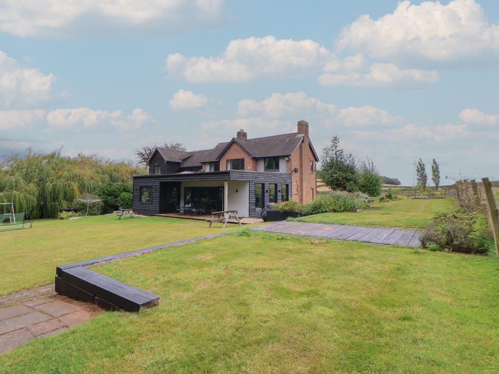 A house with a garden and decking at Rook Hall Farm in Butterton near Newcastle-Under-Lyme