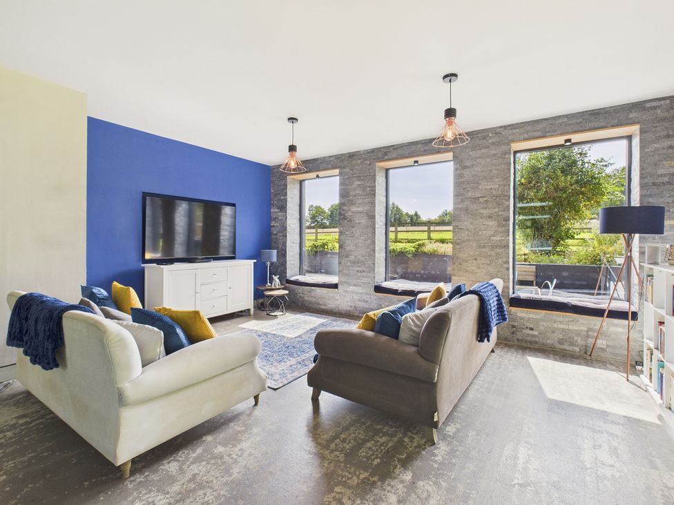 A living room with a television and seating area at Rook Hall Farm in Butterton near Newcastle-Under-Lyme