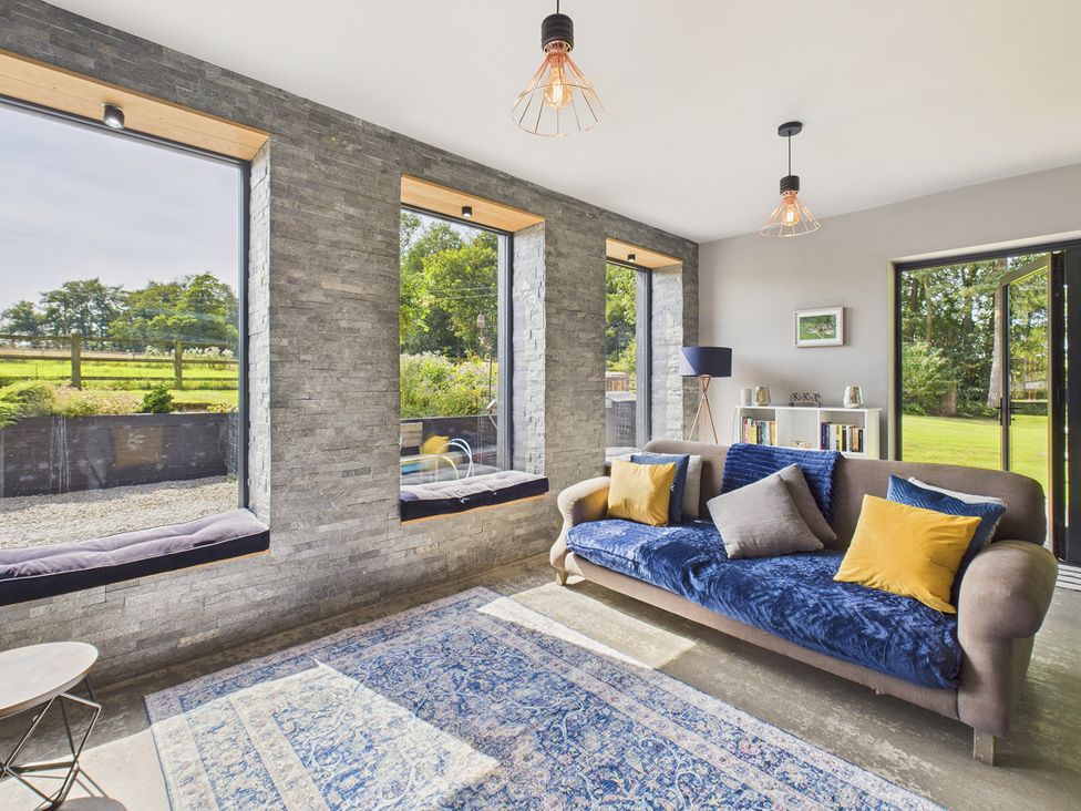 A living room with windows and a couch at Rook Hall Farm Butterton near Newcastle-Under-Lyme