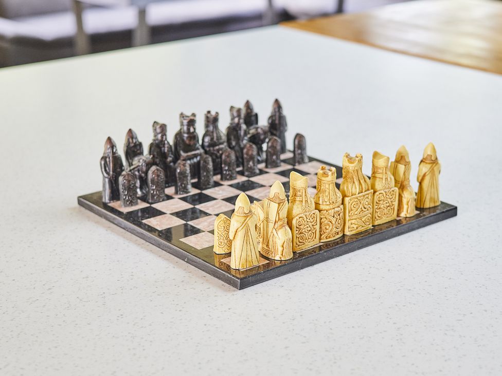 A chessboard with black and golden chess pieces at Rook Hall Farm in Butterton near Newcastle-Under-Lyme