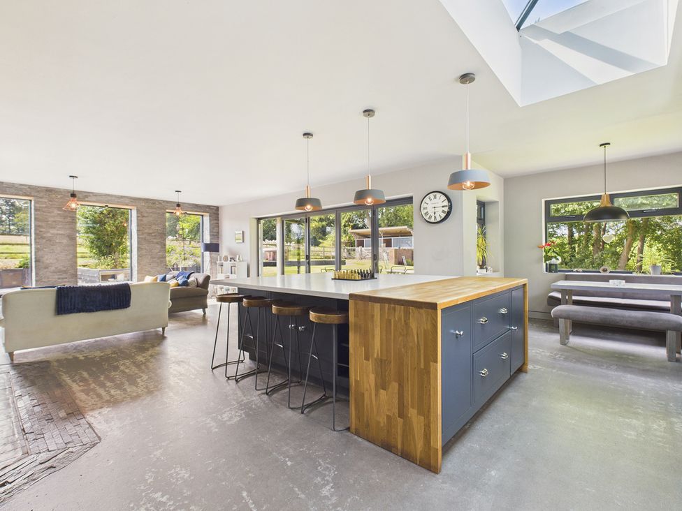 A kitchen with an island and dining area at Rook Hall Farm Butterton near Newcastle-Under-Lyme