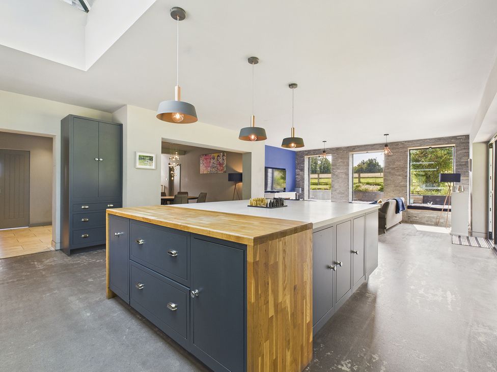 A kitchen with a large island and windows at Rook Hall Farm Butterton near Newcastle-Under-Lyme
