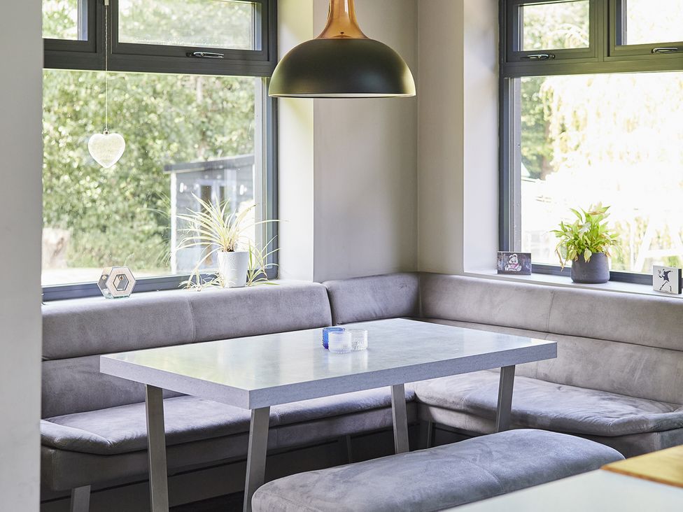 A dining area with a table and benches at Rook Hall Farm in Butterton near Newcastle-Under-Lyme