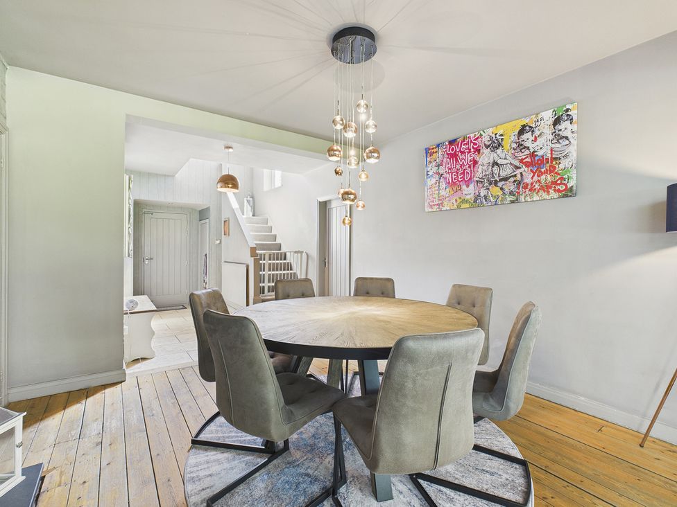 A dining room with a round table and chairs at Rook Hall Farm Butterton near Newcastle-Under-Lyme