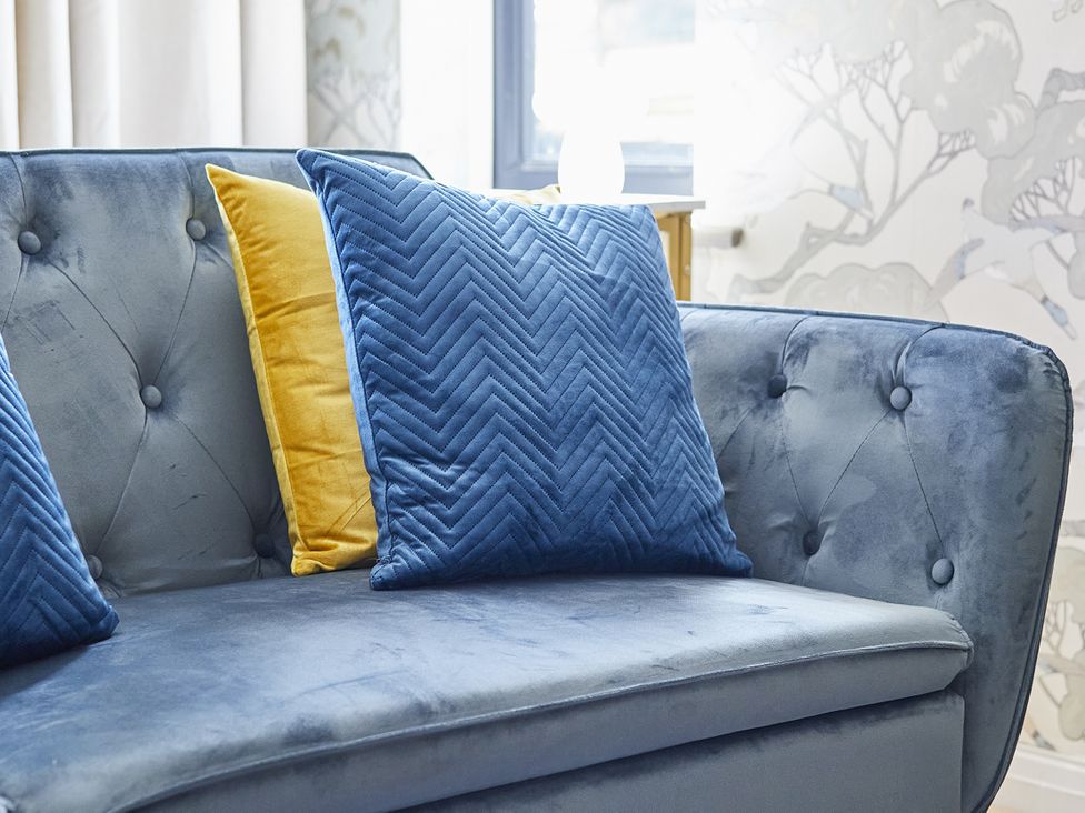 A sofa with cushions in a living room at Rook Hall Farm Butterton near Newcastle-Under-Lyme