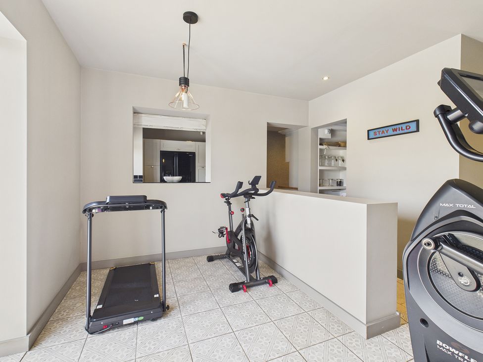 A gym with a treadmill and exercise bike at Rook Hall Farm Butterton near Newcastle-Under-Lyme