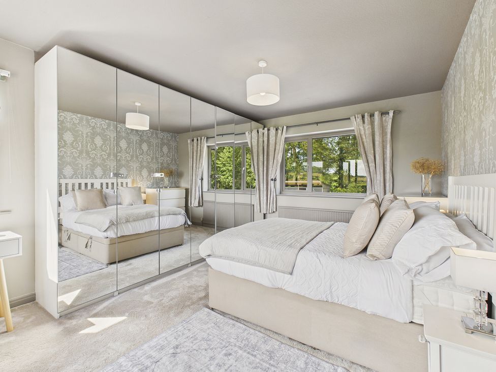 A bedroom with a bed and wardrobe at Rook Hall Farm Butterton near Newcastle-Under-Lyme