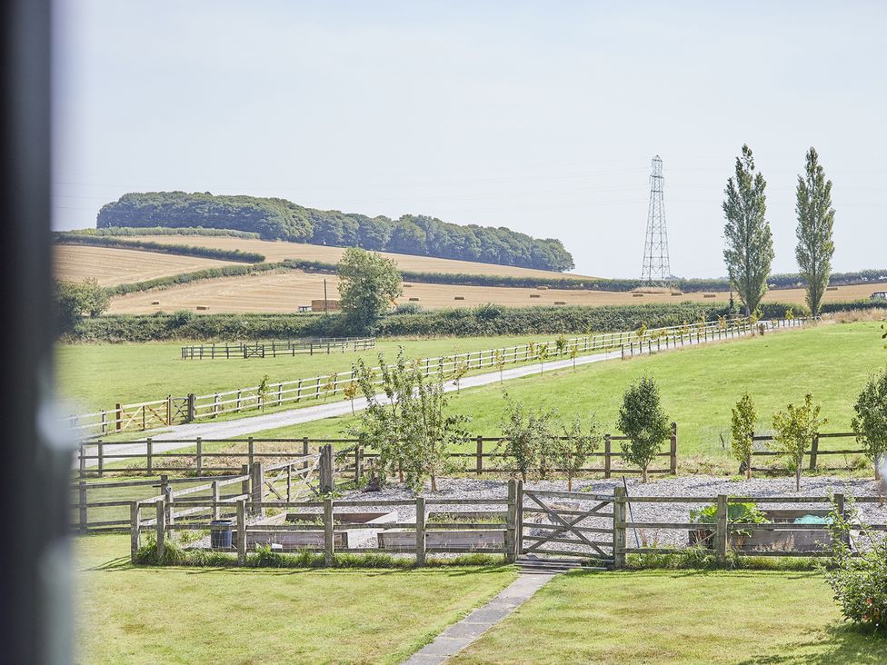 A view of a field with a fence and trees at Rook Hall Farm Butterton near Newcastle-Under-Lyme