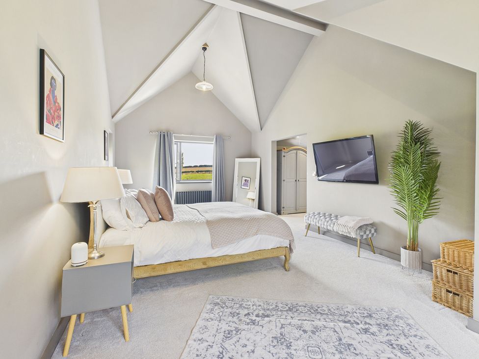 A bedroom with a bed and television at Rook Hall Farm Butterton near Newcastle-Under-Lyme