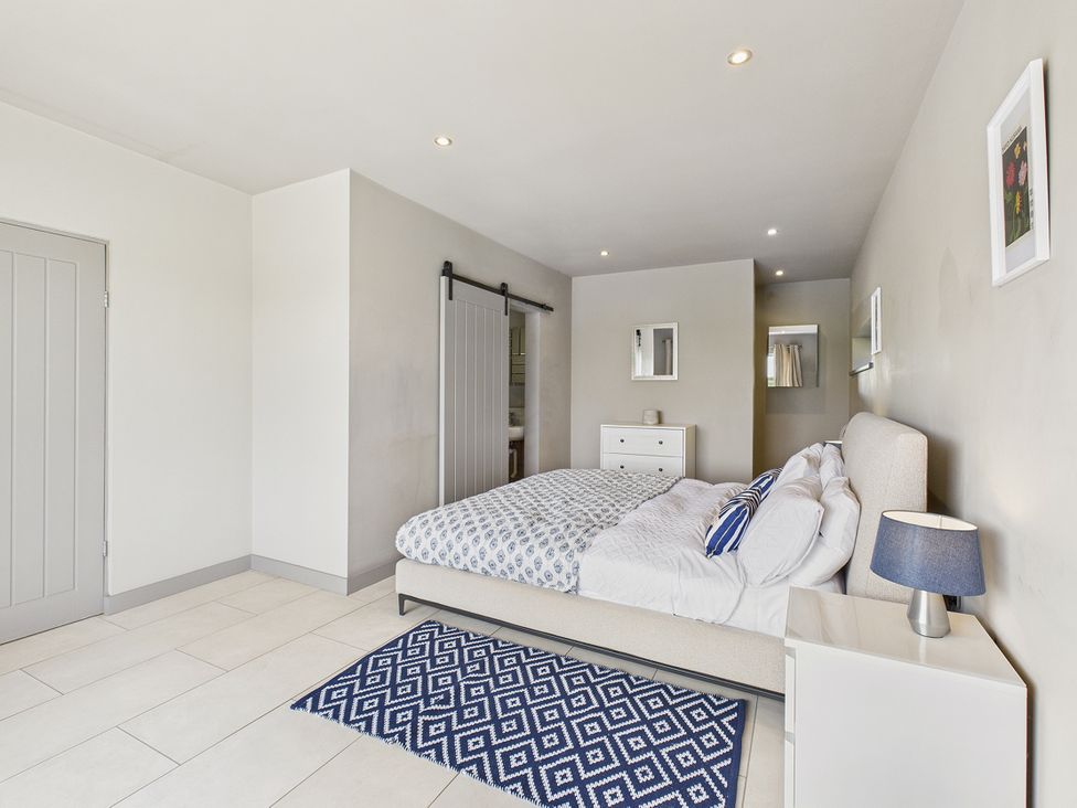 A bedroom with a bed and dresser at Rook Hall Farm Butterton near Newcastle-Under-Lyme