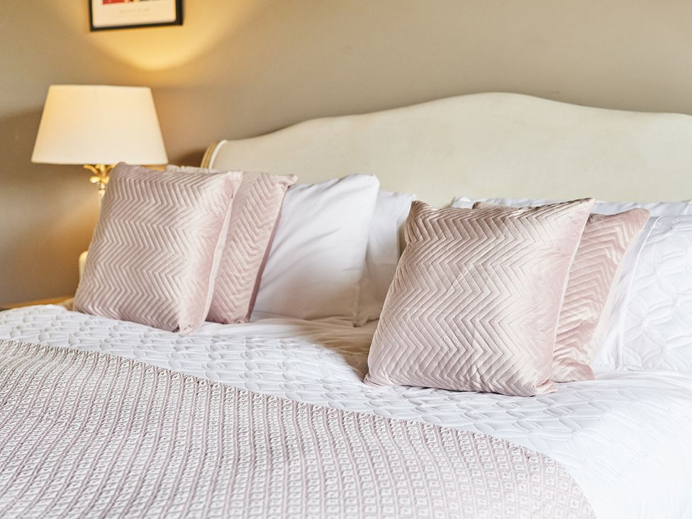 A bedroom with a bed and pillows at Rook Hall Farm Butterton near Newcastle-Under-Lyme