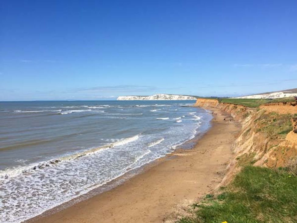 A beach with waves and cliffs at Sheepwash Barn in 