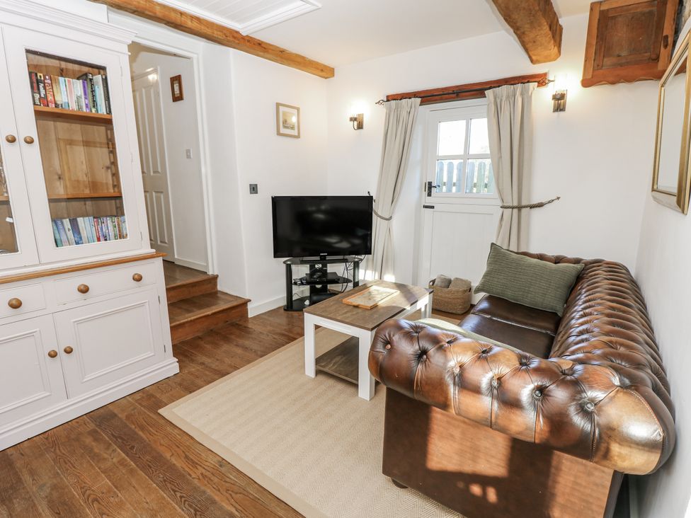A living room with a sofa and television at Sheepwash Barn in Freshwater