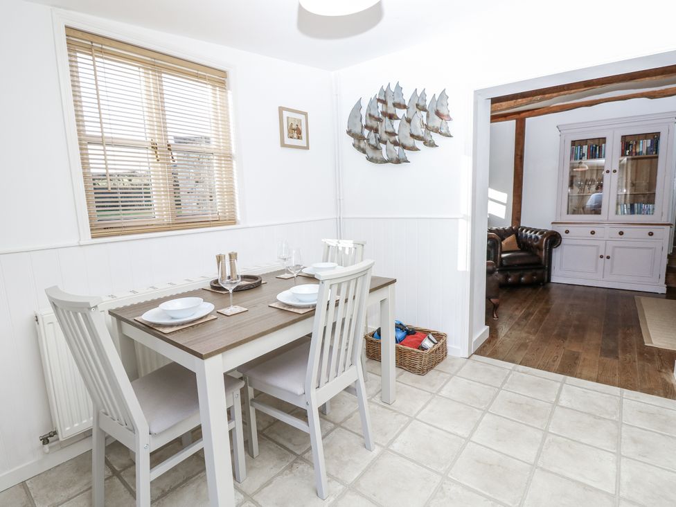 A dining area with a table and chairs at Sheepwash Barn Freshwater