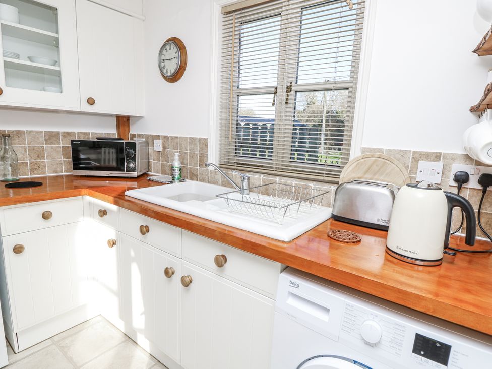 A kitchen with appliances and sink at Sheepwash Barn Freshwater