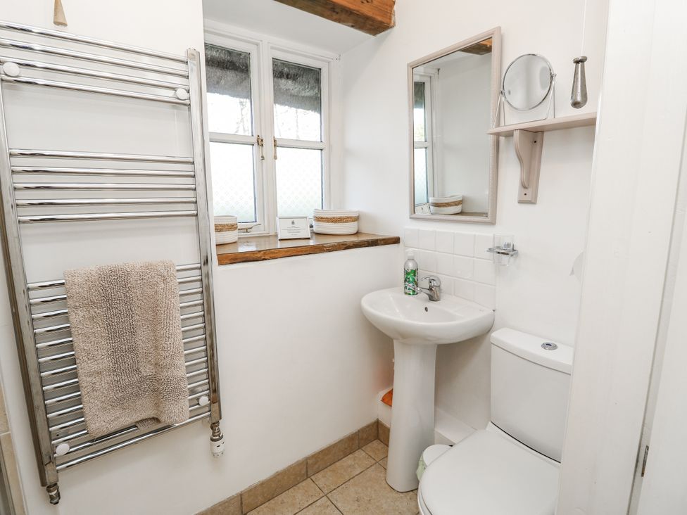 A bathroom featuring a sink and toilet at Sheepwash Barn, Freshwater