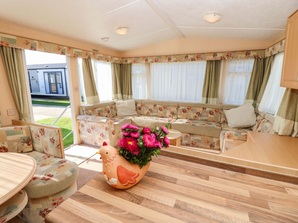 A living room with seating area and flowers at Number 38 in Chichester