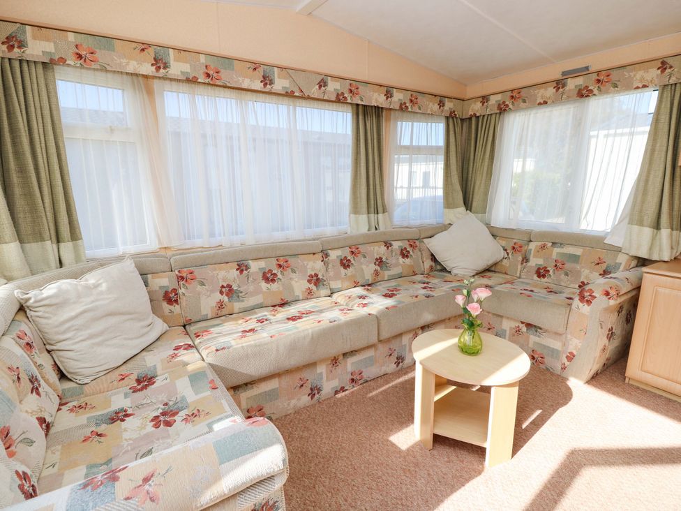A snug with a couch and coffee table at Number 38 in Chichester