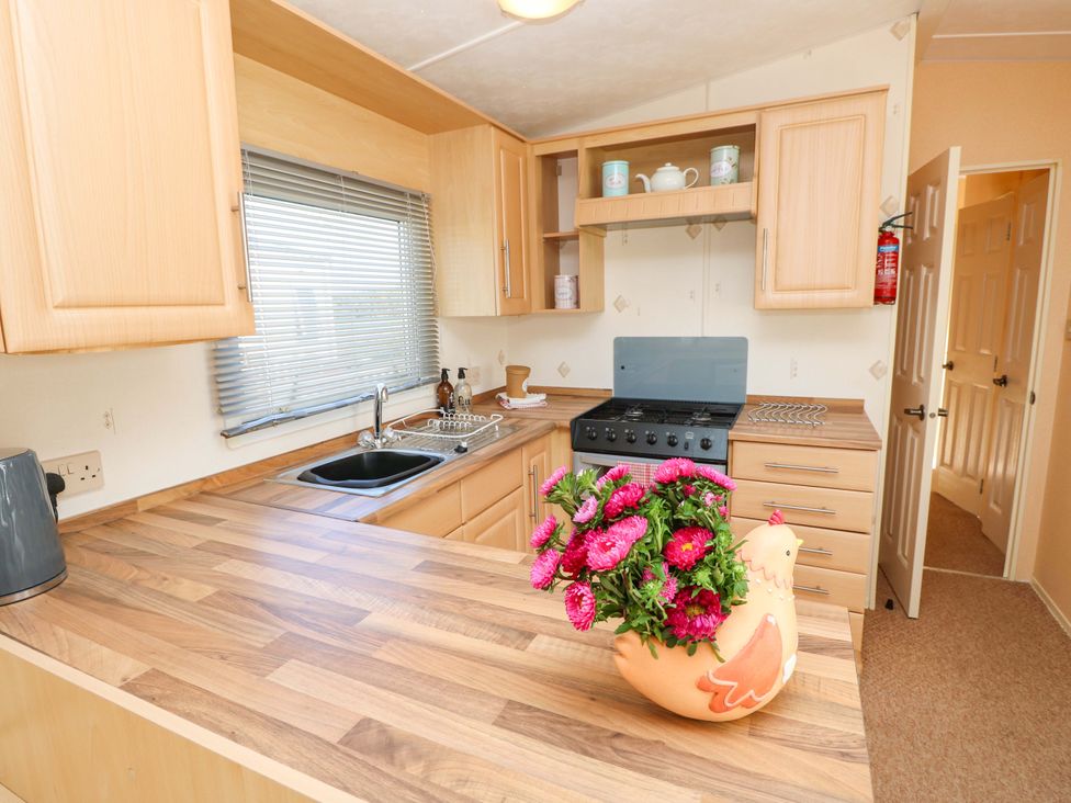 A kitchen with a sink and stove at Number 38 Chichester